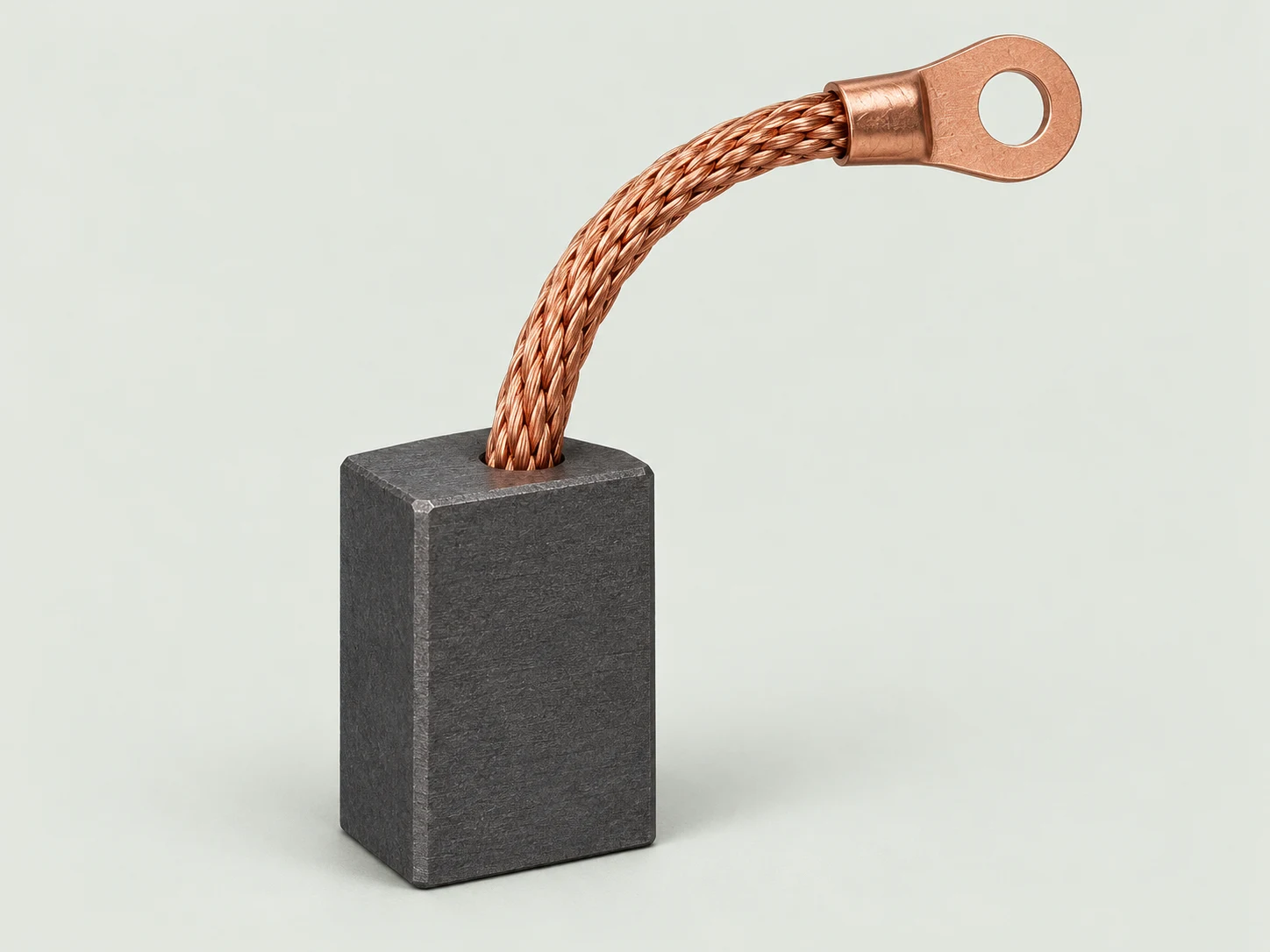 Ilustración de una escobilla: bloque de carbón con cable trenzado de cobre y terminal de anillo
